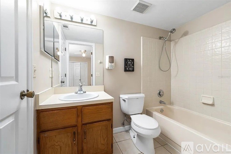 A bathroom with a white toilet, sink, and bathtub.
