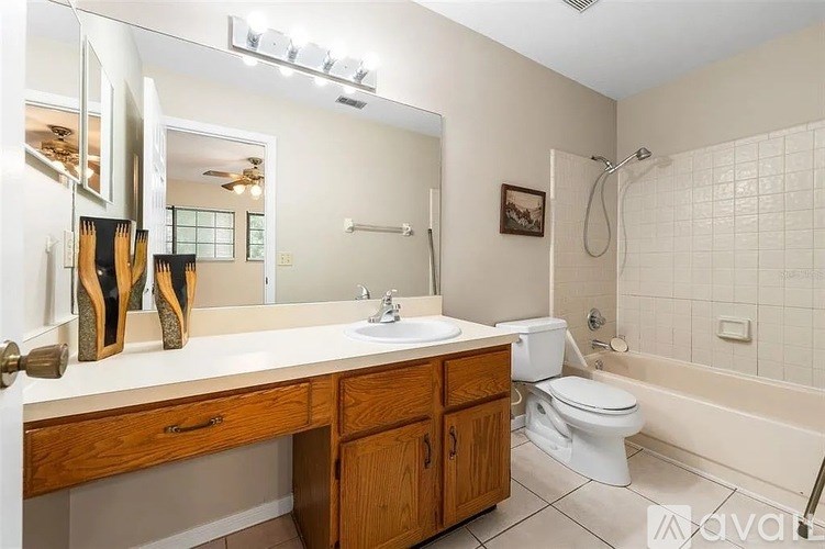 A bathroom with a white sink and a white toilet.