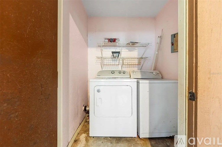 A small laundry room with a washer and dryer.