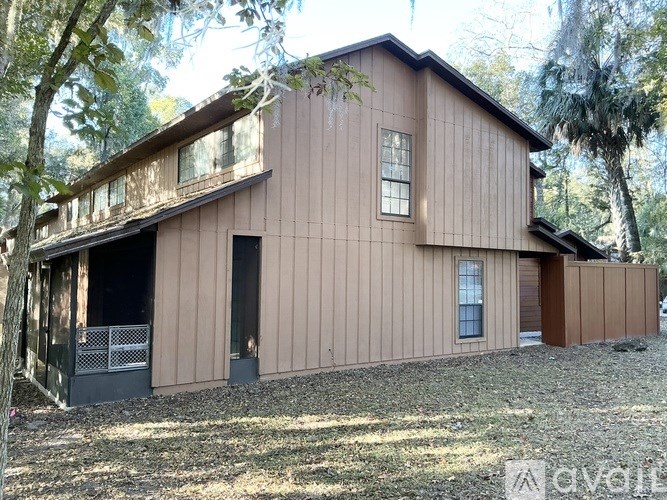 A house with a brown siding and a balcony.