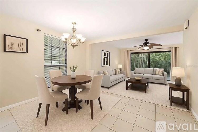 A well-lit living room with a dining table and chairs.