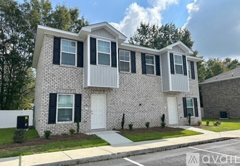 A two-story house with a white front door and black shutters.