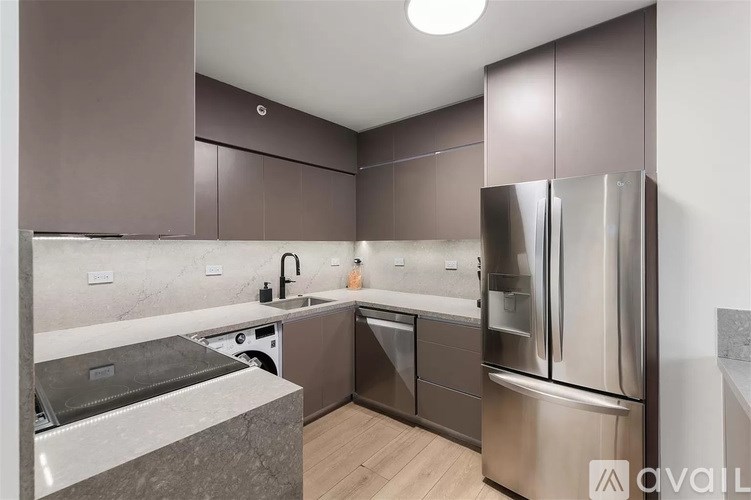 A kitchen with brown cabinets and stainless steel appliances.