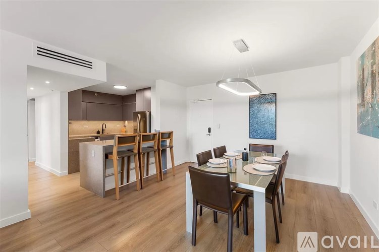 A modern kitchen with a dining table set for four.