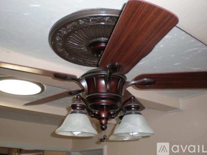 A ceiling fan with a light fixture is mounted on the ceiling.