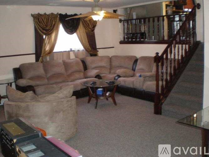A living room with a brown sofa and a coffee table.