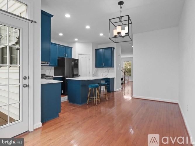 A kitchen with blue cabinets and a white countertop.