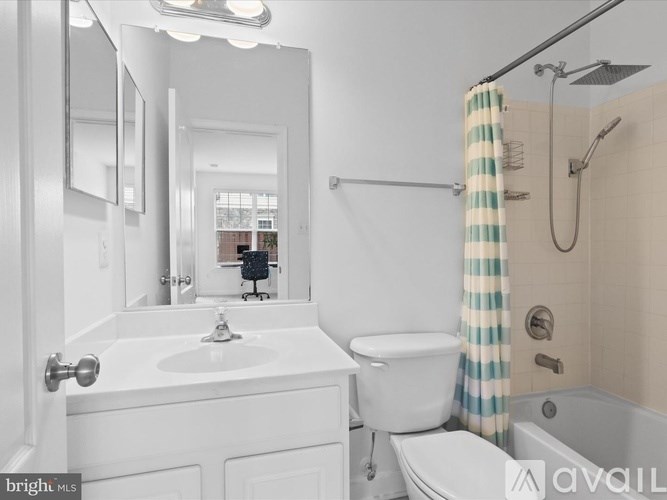 A white bathroom with a sink, toilet, and bathtub.
