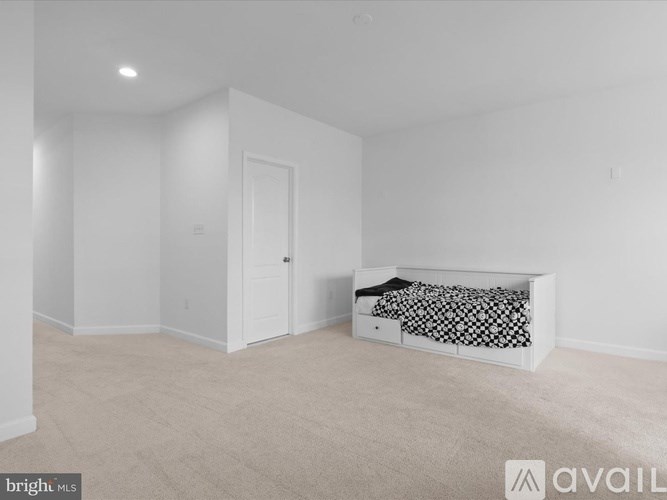 A bedroom with a bed and a dresser in it.