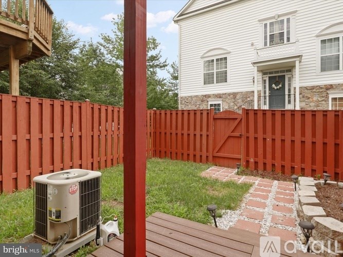 A red fence surrounds a white house.