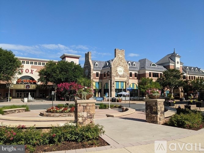 A sunny day at the Fox shopping center with a clock tower in the middle.