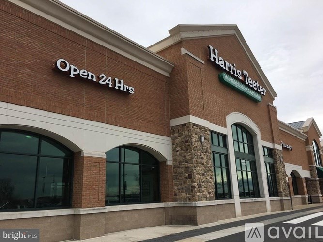 A Harris Teeter store sign indicates it is open 24 hours.