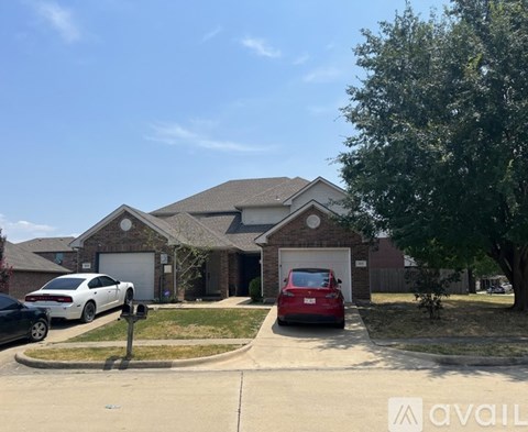 A house with a red car parked in front.