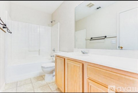 A bathroom with a toilet, sink, and shower.