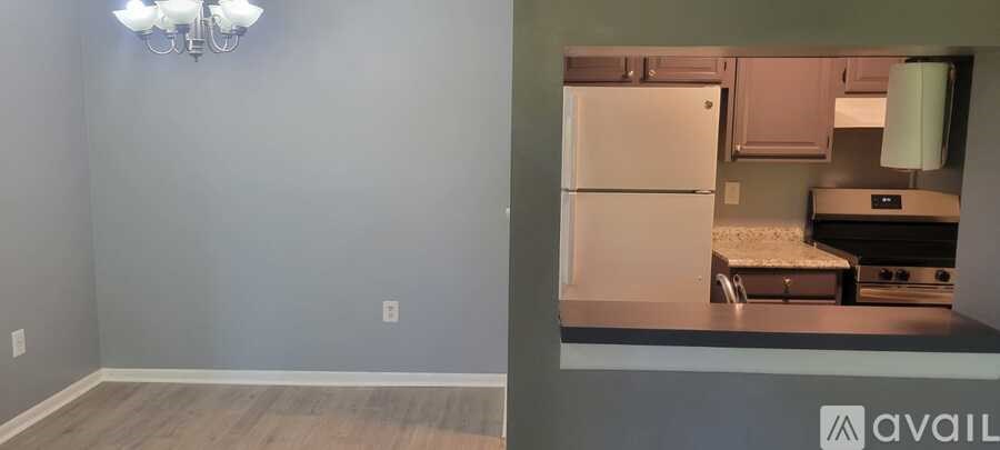 A kitchen area with a fridge and a dishwasher.