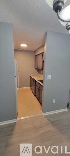 A kitchen with a refrigerator and cabinets.