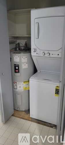 A white refrigerator with a black sticker on it.