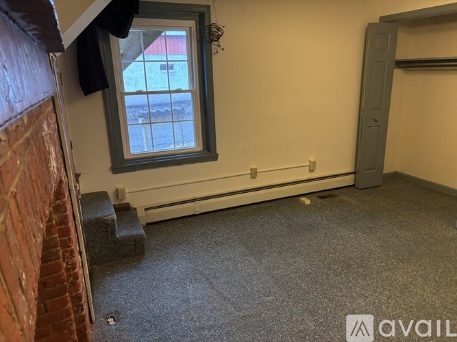 A room with a window and a door.