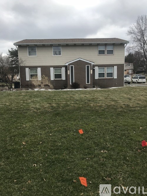A house with a lawn in front of it.