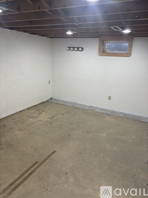 A room with a window and a ceiling light fixture.