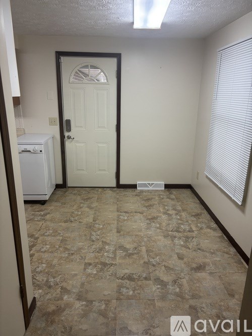A room with a tiled floor and a door.