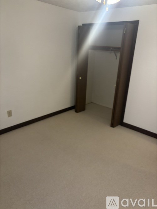 A room with a door and a mirror on the wall.