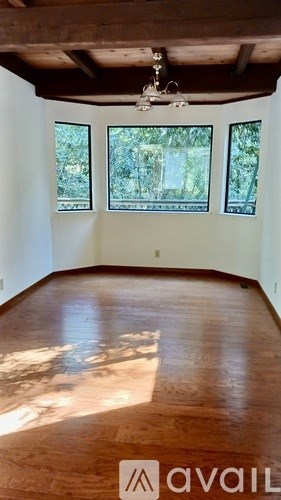 A room with wooden floors and a ceiling fan.