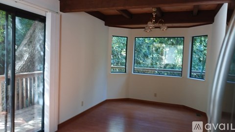 A room with a wooden floor and a chandelier.