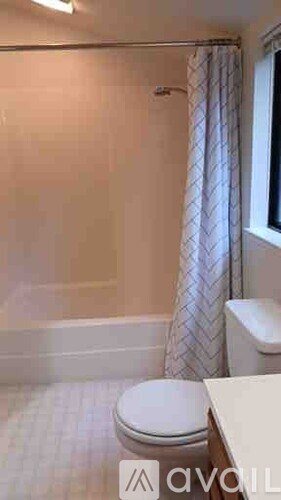 A small bathroom with a toilet and a shower.