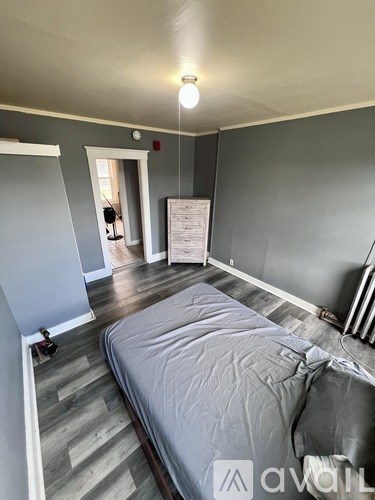 A bedroom with a bed and a window.