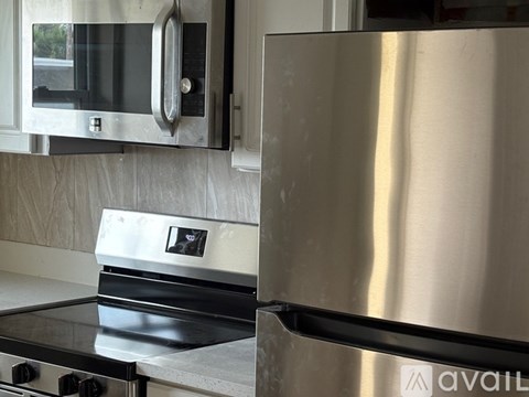 A stainless steel oven and microwave in a modern kitchen.