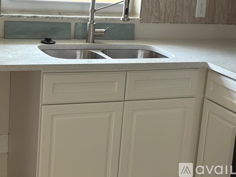 A kitchen with a sink and cabinets.