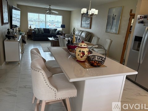 A kitchen with a table and chairs in the middle of the room.