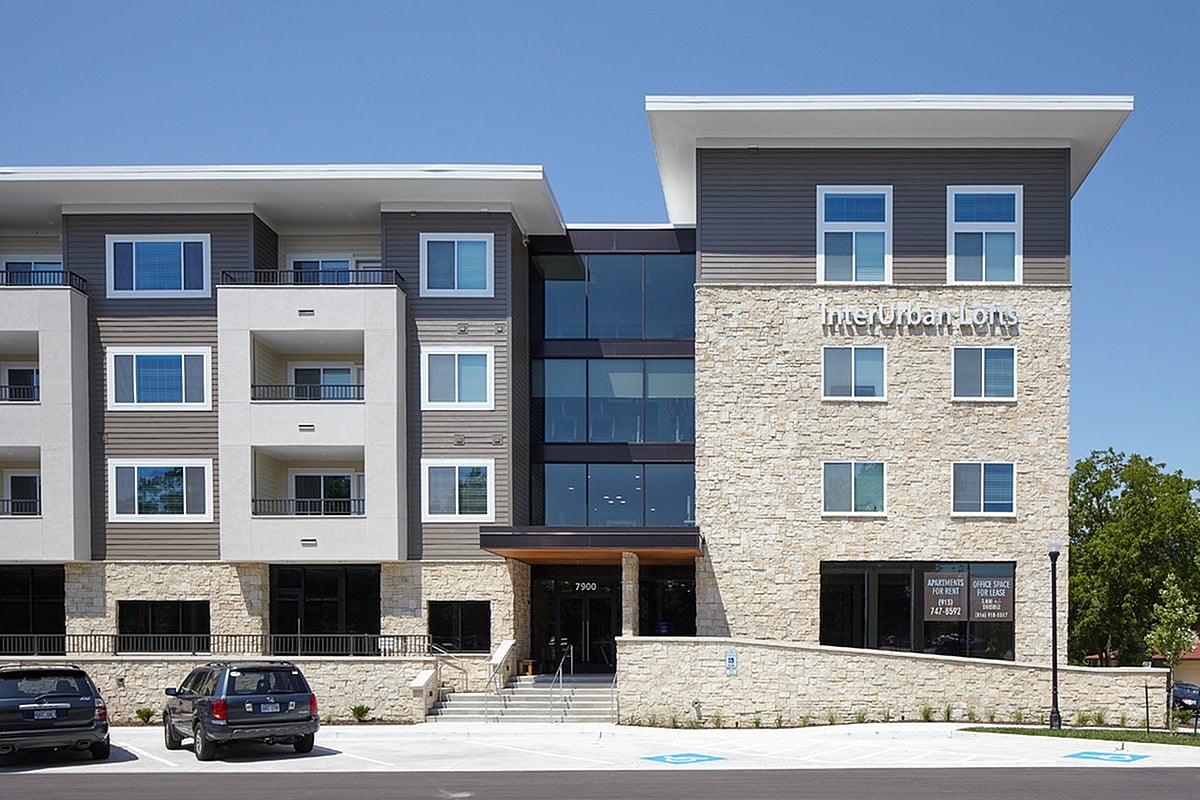 A modern building with the words "Interior Designs" on the side.