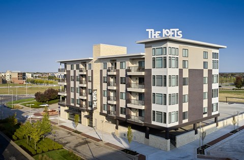 The IOTE building is a large, modern apartment complex with a spacious courtyard.
