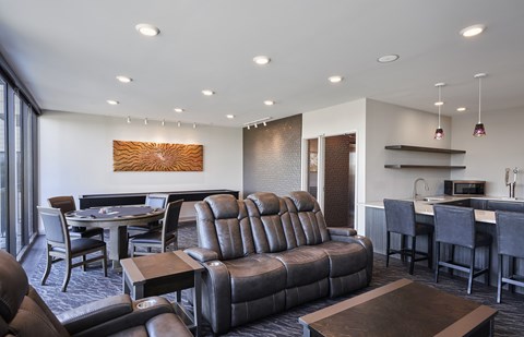 A modern living room with a brown leather couch and a wooden coffee table.
