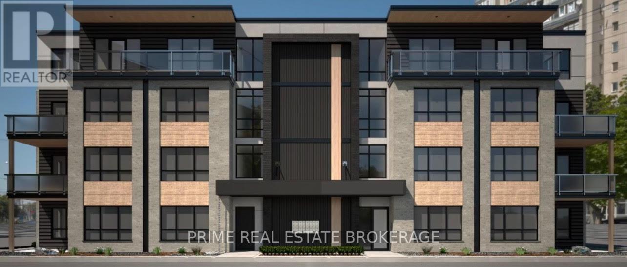 A modern multi-story building with a large entrance and balconies.