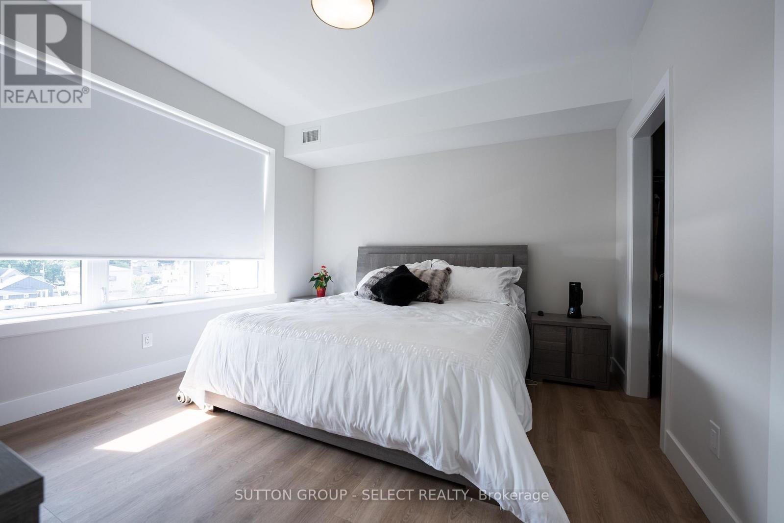 A bedroom with a large bed and a window.