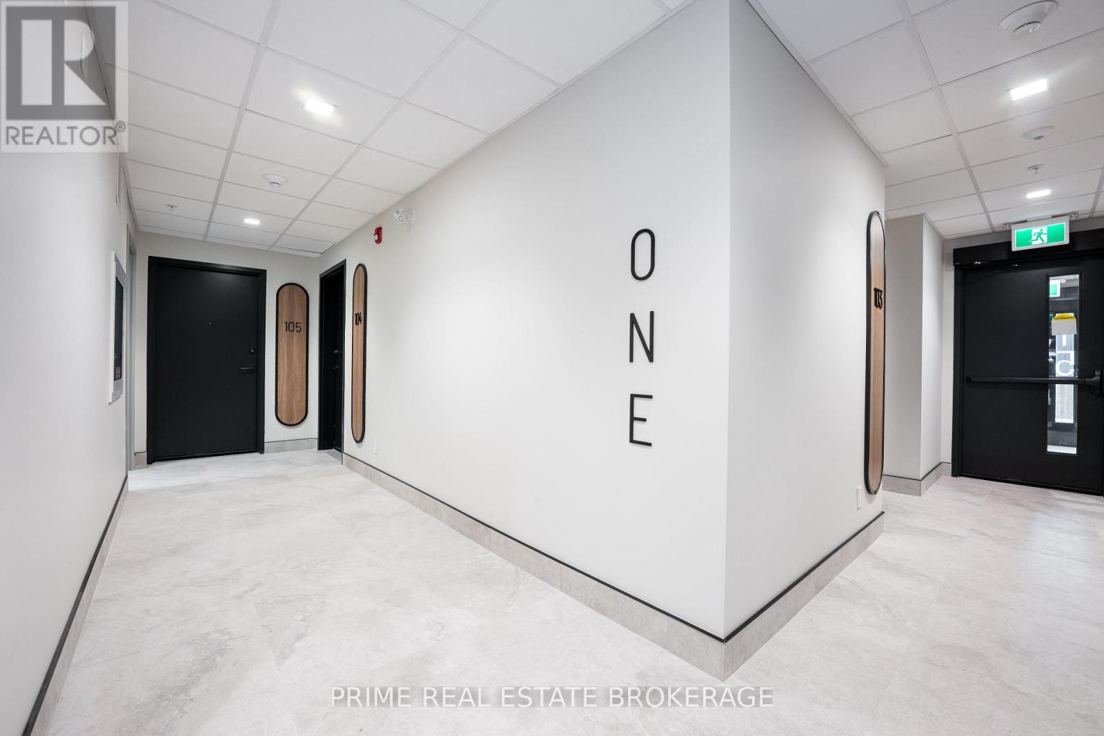 A white room with a large ONE sign on the wall.