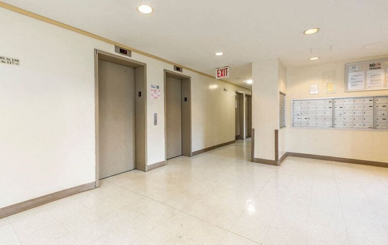 the hallway of an office building with elevators and doors