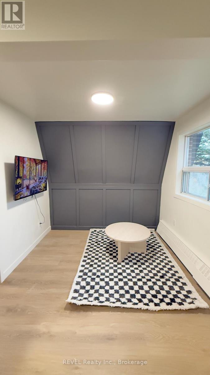 A bathroom with a toilet and a checkered rug.