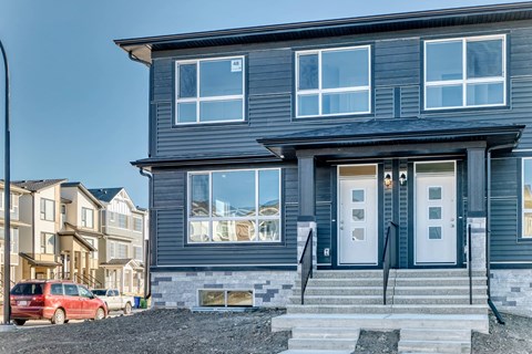 A modern two-story house with a grey exterior and white trim.