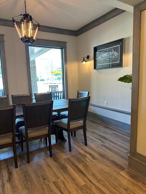 A dining room with a table and chairs.