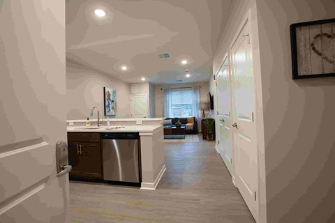 A kitchen with a dishwasher and a refrigerator.