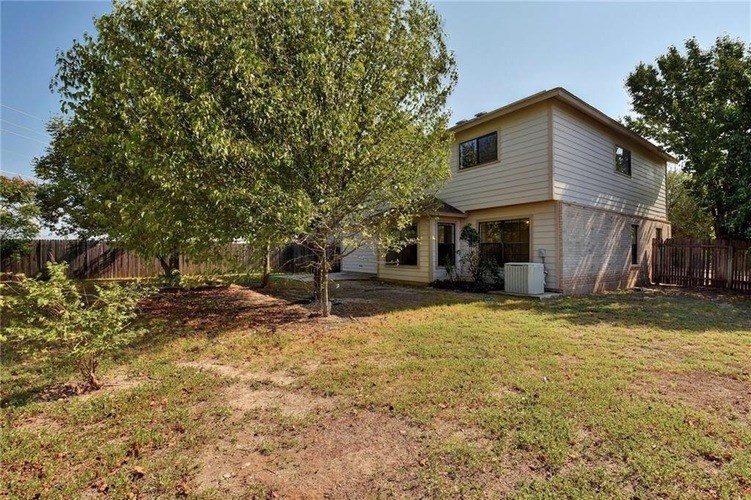 A house with a tree in front of it.