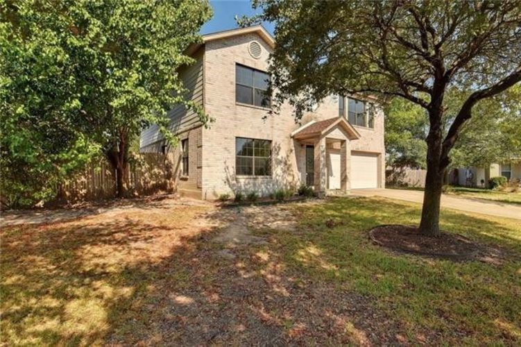 A house with a tree in front of it.