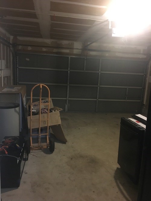 A room with a ladder and a cabinet.