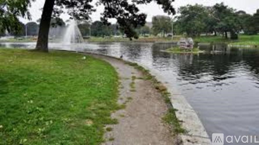A park with a pond and a fountain.