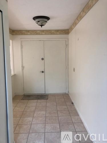 A white door with a mat in front of it.