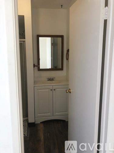 A white door with a mirror above it.